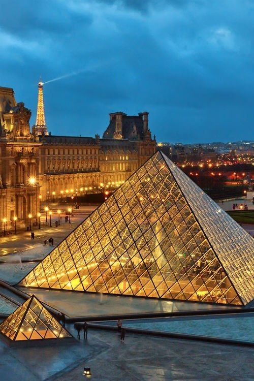 The Louvre Pyramid illuminated at dusk